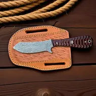 Leather case with a knife on a wooden surface