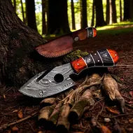Knife with a wooden handle and red blade tip on a tree stump in a forest setting